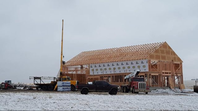 Agricultural pole-barn roof trusses with a wide clear span
